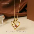 Close-up of gold titanium steel heart necklace with rose detail and zircon inlays - Gold Red Stone Necklace N0451G