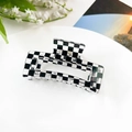 Classic black and white checkered hair claw clip with acrylic finish on a white plate - 8.5cm Square - Transparent Checkerboard
