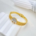 Detailed close-up of tree of life engraving on a two-tone gold and silver steel bangle - Tree of Life Triple Line Gold