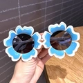 Kids funny blue flower shaped sunglasses with white wavy trim and dark grey lenses - Blue Flower