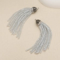 Macro detail of light blue crystal bead tassels with rhinestone-encrusted metal caps - Light Gray