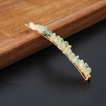 Macro shot of natural green crystal stones on a gold-plated hair clip with metal finish - Prehnite Gold