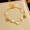 Macro detail of gold layered bracelet featuring colorful enamel butterflies and pearls - Colorful Enamel Butterfly Style(B1646) / Gold