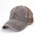 Close-up of distressed washed canvas and breathable mesh detail on a vintage baseball cap - Coffee