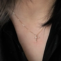Elegant gold S925 sterling silver cross necklace with clear gems worn by a model - 40+5cm / 14K Gold