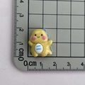 Macro shot of a small yellow resin dinosaur charm with ruler for size measurement - Style 1 / Yellow Dinosaur