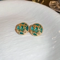 Detail of vintage gold earrings with blue enamel flowers on a white textured ceramic plate - Circle Shape / Blue Gold