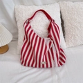 Close-up of red striped canvas tote bag featuring metal logo plate and lace ribbon detail - Red Stripe With Ring