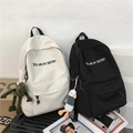 Minimalist canvas backpack in black and white with letter print and plush charms - Single Bag / Black