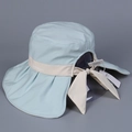 Detail of light blue sun hat with wide brim, neck flap and beige decorative bow strap - M (56-58cm) / Blue