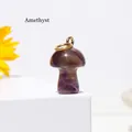Mini natural amethyst mushroom pendant with golden metal ring on white platform display - Amethyst