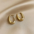 Detailed view of polished golden teardrop hoop earrings resting on champagne silk fabric - Gold Polished Thick Teardrop Hoop (A52)