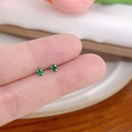 Minimalist green zircon stud earrings with silver plating shown in a hand comparison - Vertical Prong No.3 / Green
