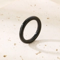 Polished black ring on stone background, featuring a sleek minimalist design and 18k gold accents - US 6 / Thin Plain Band (3mm) / Black (KR34643-K)