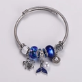 Macro view of ocean charms with blue tail and turtle on twisted silver bracelet - Blue Sea Turtle & Fish Tail Style