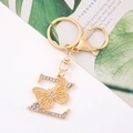 Detailed macro view of golden alloy letter Z keychain with crystals and butterfly accent - Letter Z