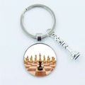Silver metal chess keychain with glass pendant showing board and extra queen charm - Board Scene