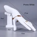 White resin hand model jewelry stand displaying rings and bracelets, size 27x13x9cm - Armrest Hand / White