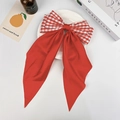 Elegant red satin and checkered bow hair clip with long ribbons on a white display tray - Red Small Gingham