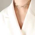 Silver twist chain necklace in French minimalist style on female model with white blazer - Necklace / Steel