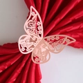 Rose gold butterfly napkin ring with laser-cut hollow pattern on red satin fabric - Pink