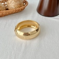 Minimalist wide gold bangle featuring a highly polished mirror finish in a modern lifestyle setting - French Minimalist Thick Bangle (SL299) / Gold