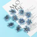 Macro detail of 10 gradient blue artificial plum blossom heads with fabric textures - Blue