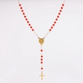 Detail of red crystal rosary necklace with gold medal and crucifix on white background - Red