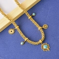 Collier trèfle doré avec turquoise bleue et breloques arbre de vie sur fond bleu chic - Collier
