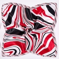 Macro view of silky texture and swirl pattern on red and black square neck scarf - Three-Color Lines