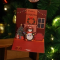 3D pop-up Christmas card featuring a cute penguin and fireplace on a wooden background - Model H662 (Fireplace Scene)