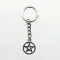 Vintage silver peace sign keychain with star pendant and metal ring on white background - Pentagram
