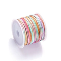 Macro detail of rainbow gradient braided cord wrapped on a white spool for DIY jewelry - Color No. 5