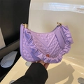 Detail of lavender quilted faux leather handbag with ruffled strap and gold hardware - Purple