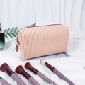 Orange and white striped seersucker makeup bag with a zipper and round tag - Orange