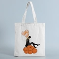 Close-up of canvas tote bag with fashionable Halloween pumpkin and balloons print - Woman on Pumpkins