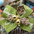 Green linen Christmas bow with white script text and gold holly leaf accent - Christmas Linen Series 2
