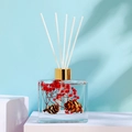 100ml glass reed diffuser with red dried flowers and pine cones in golden ring bottle - Perfume Lover [100ml]
