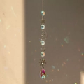Detail of silver suncatcher with crystal prisms reflecting rainbow light on wall - Style 5 (43cm, 30g)