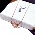 Rose gold angel wing necklace with a floating diamond ring pendant on a display card - Dancing Stone Rose Gold / Rose Gold