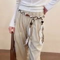 Close-up of woven ethnic waist rope with colorful beads and white cotton fringe detail - Coffee Geometric Braided Waist Chain