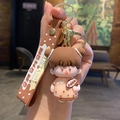 Cute cartoon girl bubble tea keychain featuring a pink dress and brown wrist strap - Milk Tea Girl