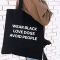 Black canvas tote bag with white slogan print and spacious interior for women - Slogan Print
