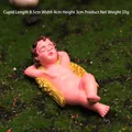 Sleeping Cupid figurine garden ornament with golden wings on green grass, 8.5cm length - Cupid