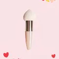 Close-up of heart-shaped sponge makeup brush with ergonomic pink handle and white tip - Single Pack / Rose Gold Tube + Beige Teardrop Head