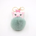 Detail of pink pig plush keychain with green pompom and gold hardware on white background - Matcha Green