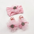Detail of pink knitted baby headband and soft shoes with mesh flower and ribbon bows - Pink