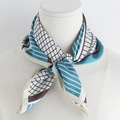 Detailed view of a geometric silk-like scarf with blue and brown patterns on a white base - Sky Blue / 70x70cm