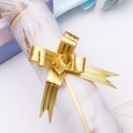 Macro view of gold plastic pull bow ribbon with metallic texture for gift wrapping - Gold Gold Edge