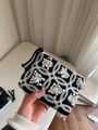 Detailed close-up of a small black canvas pouch with white floral embroidery and zipper - 3D Anemone Embroidery